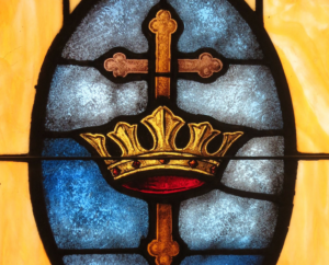 stained glass window with crown and cross