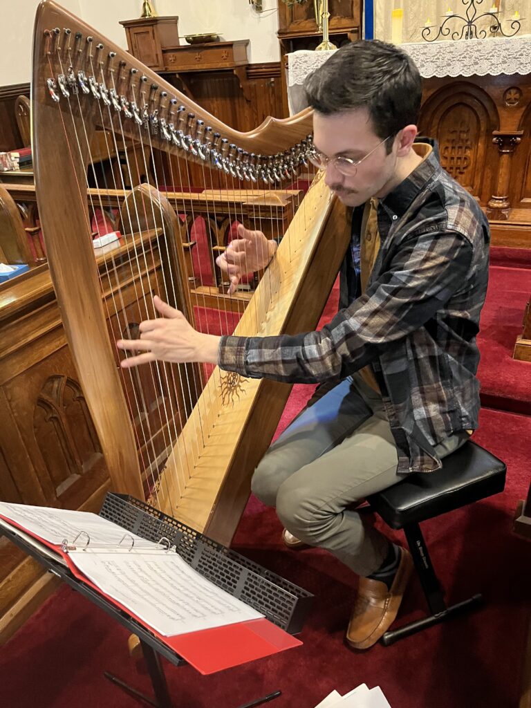 man playing the harp