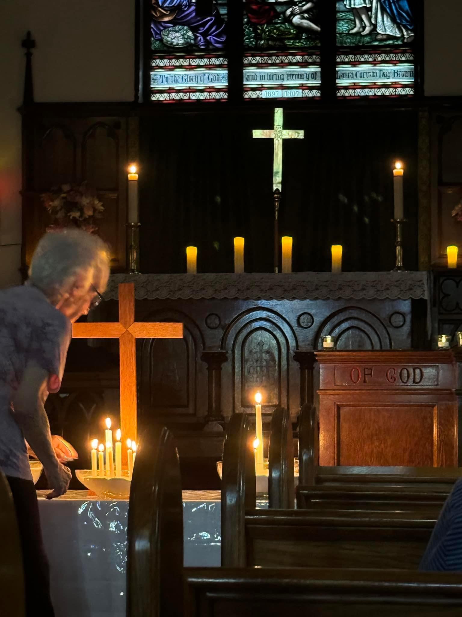 woman lighting candles during Taize worship