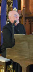 man singing and playing the piano