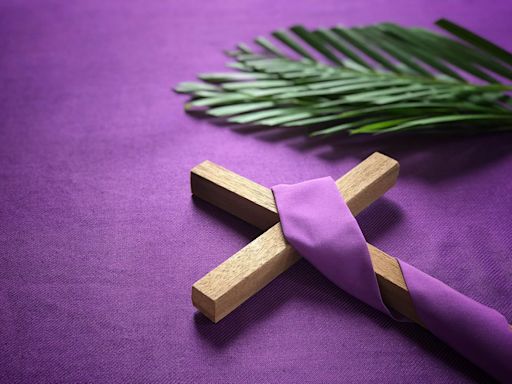 wooden cross next to palms