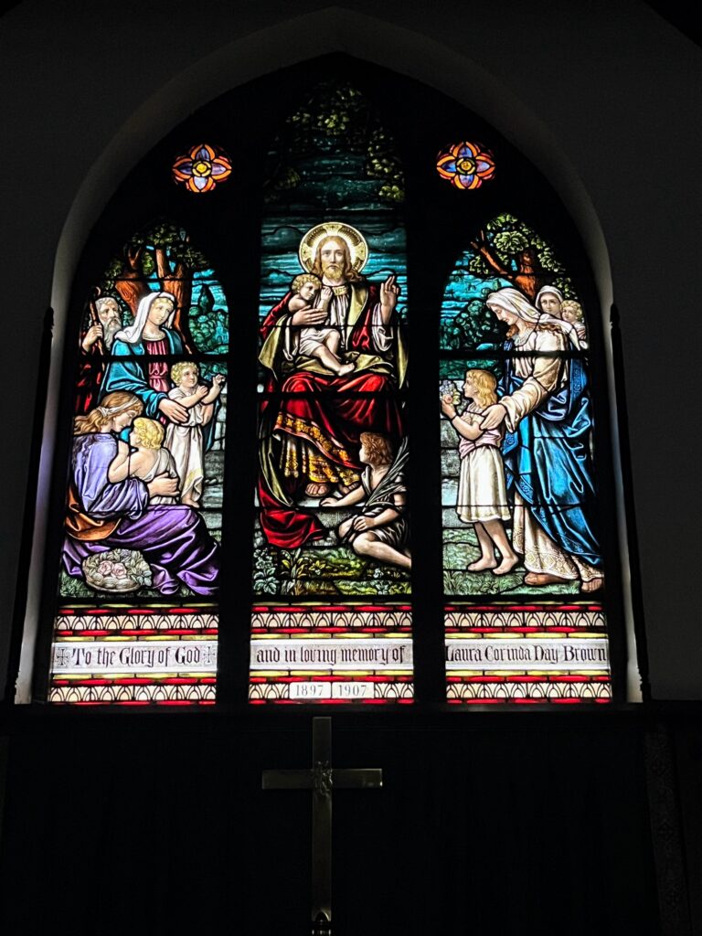 stained glass window above altar